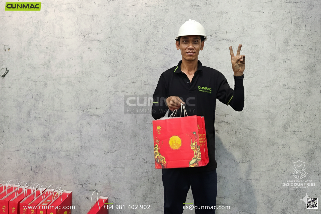 CUNMAC employee celebrating Mid-Autumn Festival with company gifts.